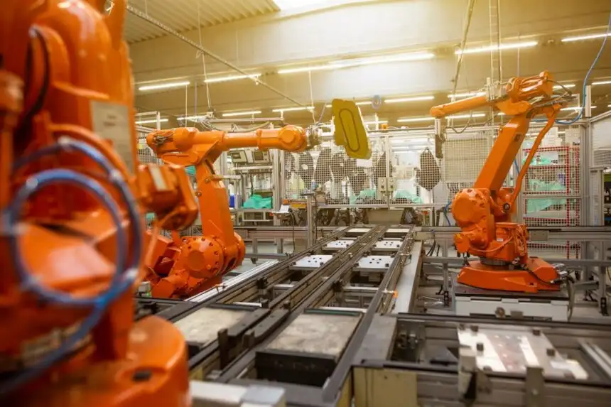 Factory automation with robotic arms representing Industry 4.0 in Indonesia