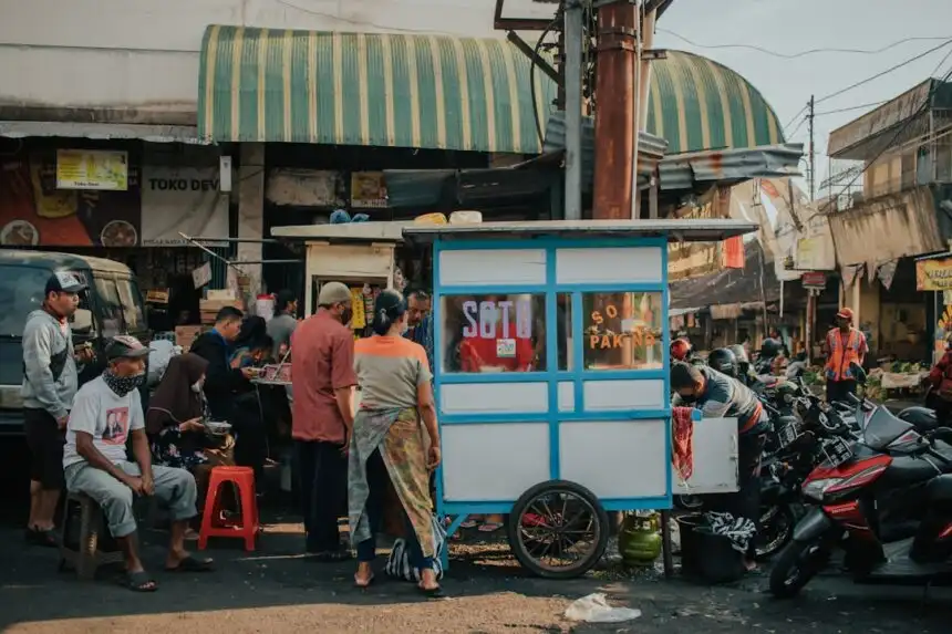 Indonesian small business owner at food stall representing UMKM going digital