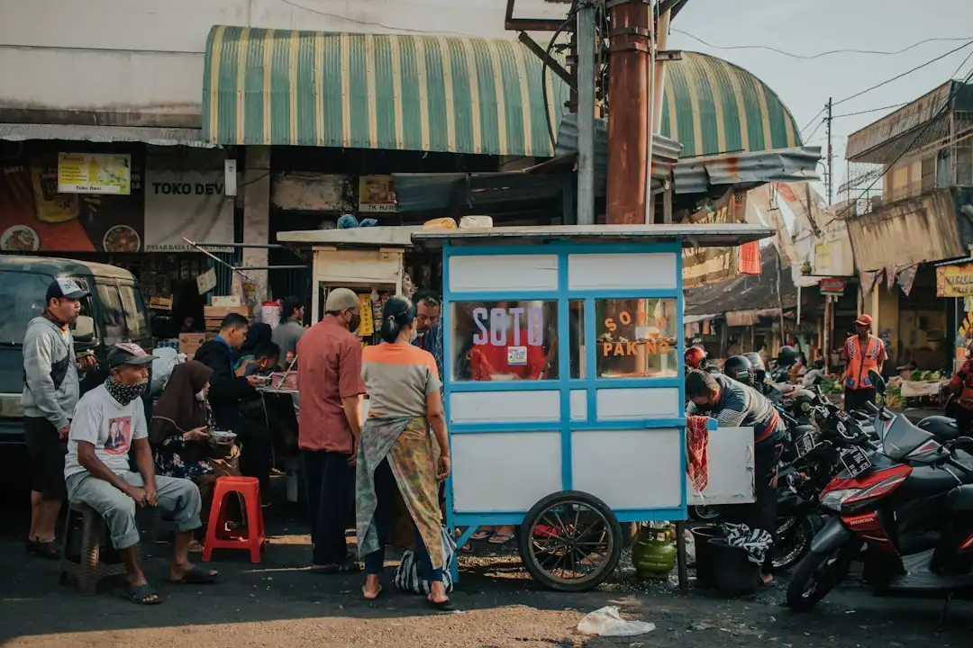 Indonesian small business owner at food stall representing UMKM going digital